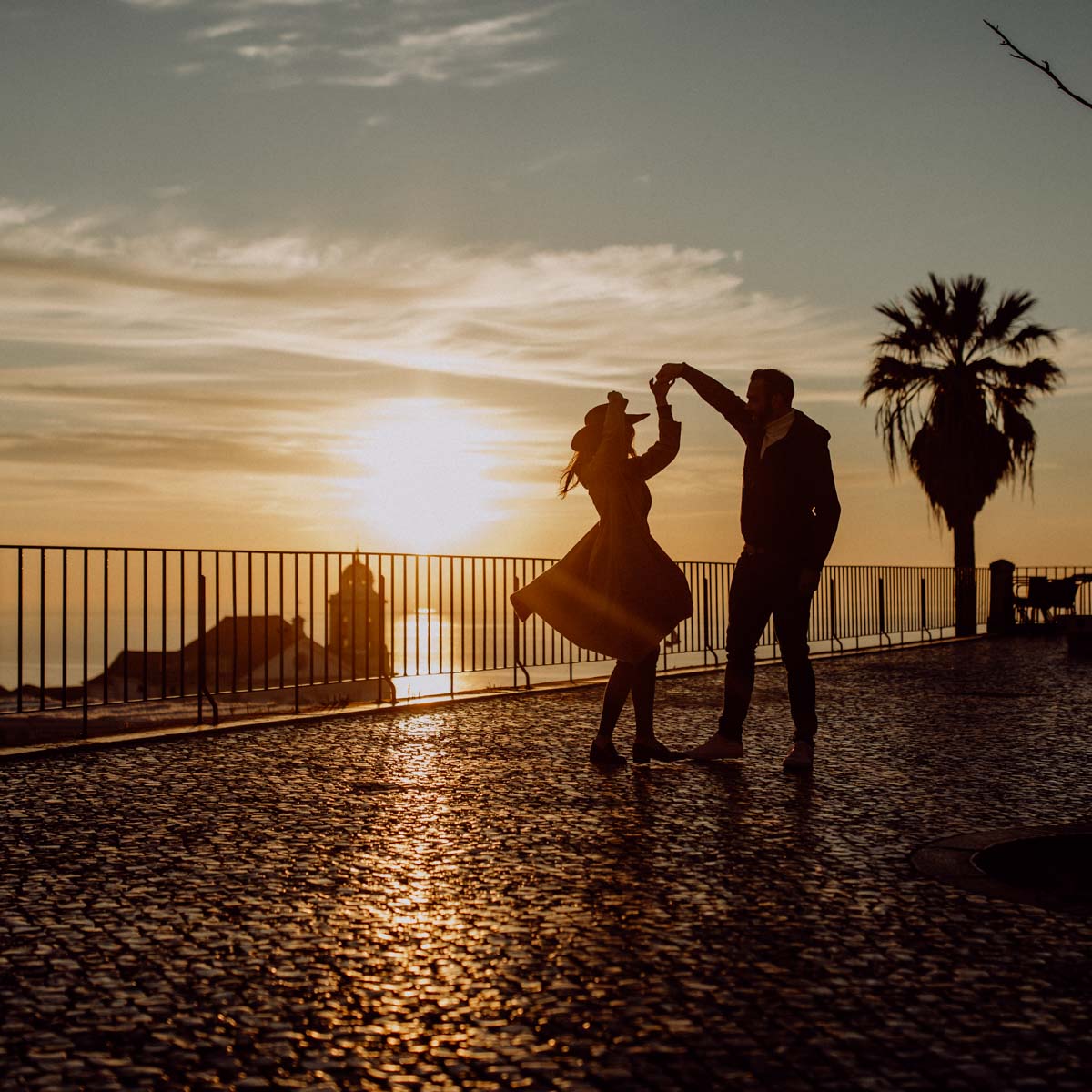 Lifestyle portrait, couple dancing against the light on a terrace in Lisbon, Portugal, expressive photo shoot at sunrise :: photo copyright Karin Bergmann
